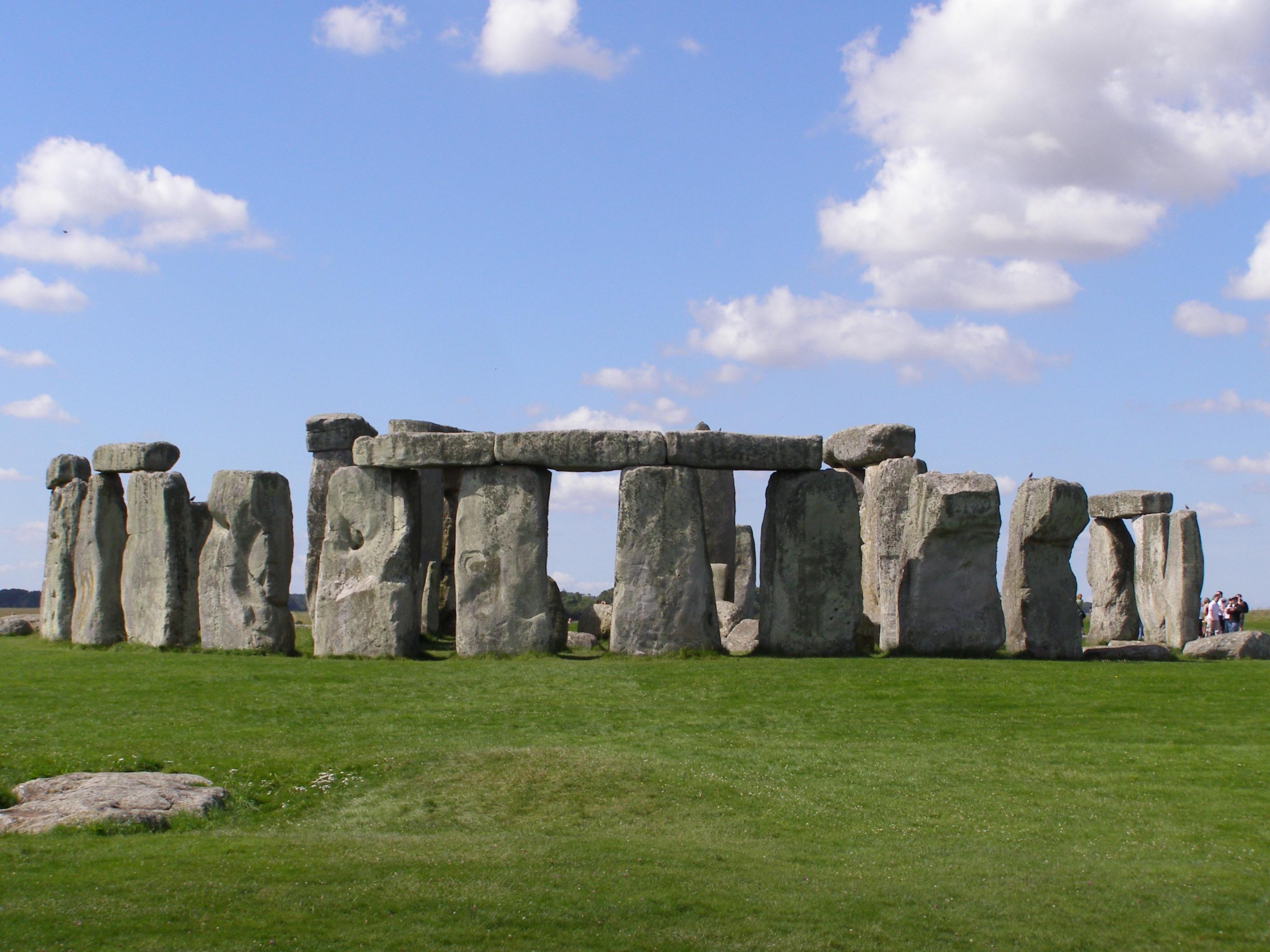 Stonehenge at dawn — the trilithons silhouetted against a midsummer sky over Salisbury Plain